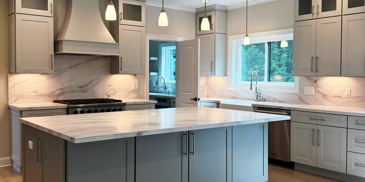 Kitchen with custom cabinetry, large island, pendant lighting, and premium finishes.
